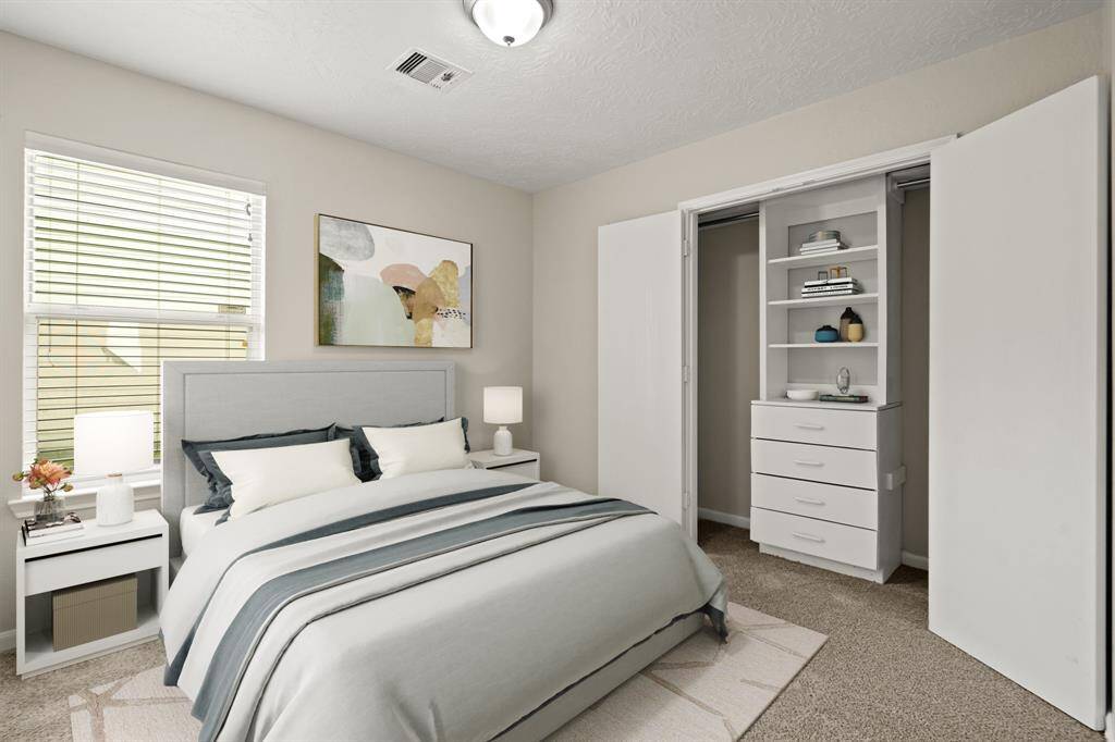 Virtually Staged: Secondary bedrrom with carpet floors, a built-in closet, and a window with privacy blinds.