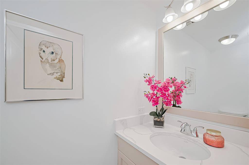 HALF BATH FOR YOUR GUESTS IN THIS BEAUTIFUL MALIBU.  NEW QUARTZ COUNTERTOP AND LIGHTING.