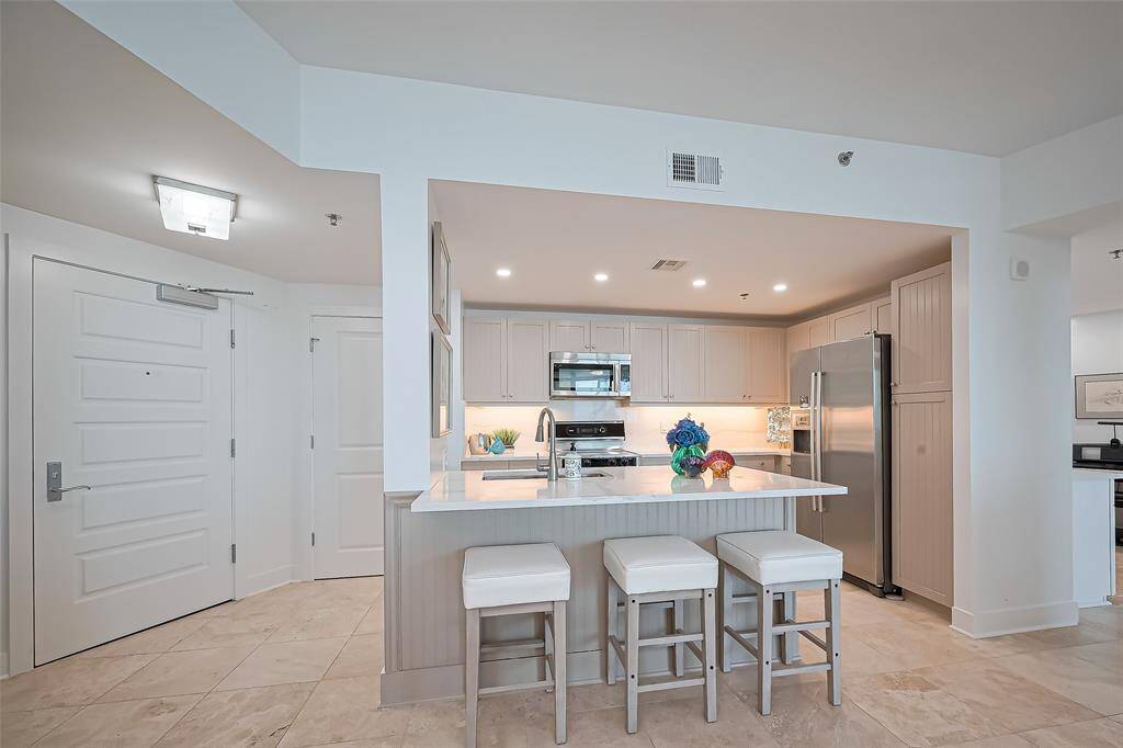 BEADBOARD ISLAND AND NEW BACKSPLASH TOO ! TONS OF EXTRA STORAGE AND CABINET PULL OUT DRAWERS.