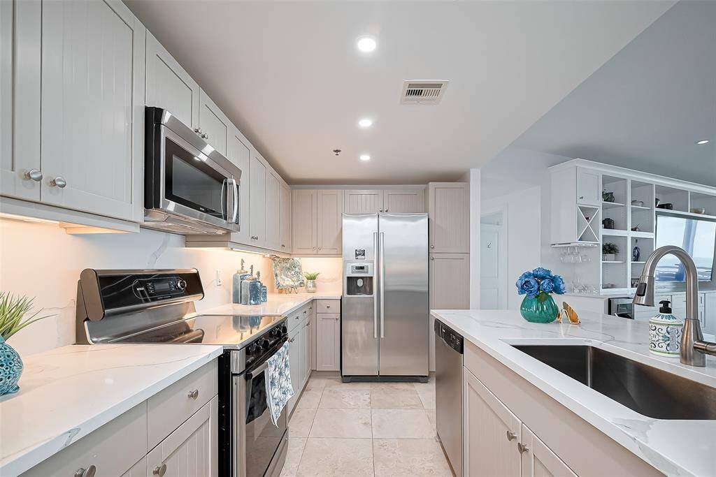 NEW QUARTZ COUNTERTOPS, BACKSPLASH, STAINLESS STEAL APPLIANCES, PULL OUT SHELVES, UPGRADED SINK AND LIGHTING.