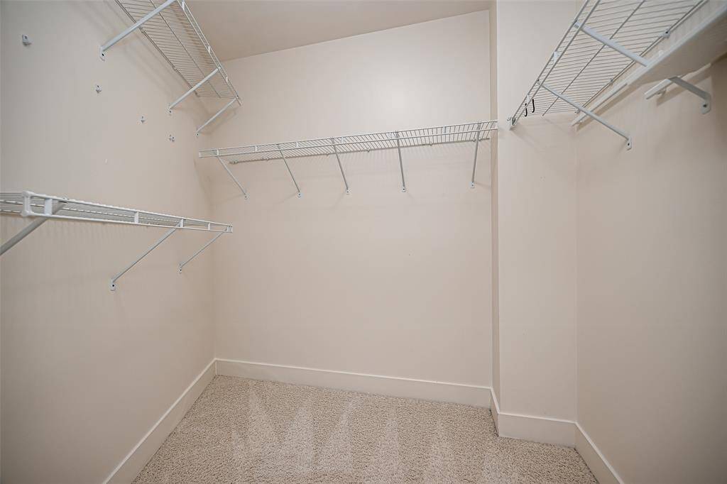 Spacious master suite with 10 ft ceilings, elegant crown molding, and direct access to a private patio. Enjoy stunning views from every angle.