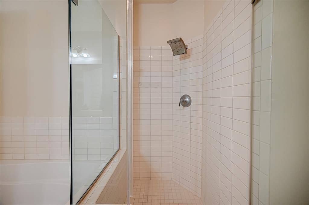 Large soaking tub in Master bath with tile backsplash.