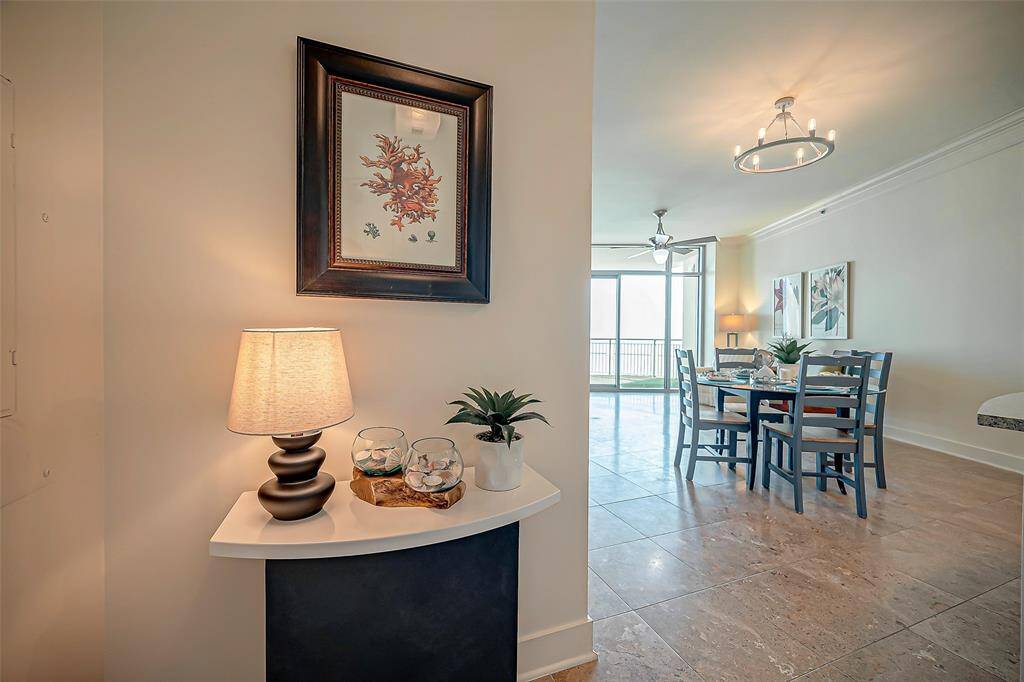 Coastal chic white kitchen cabinets with large breakfast bar area.  Custom lighting and stainless steel appliances. Large pantry off kitchen and travertine flooring throughout.  This "SIGNATURE" Malibu has a wall oven and also a stovetop. New refrigerator, oven, garbage disposal, dishwasher and microwave in 2023!
