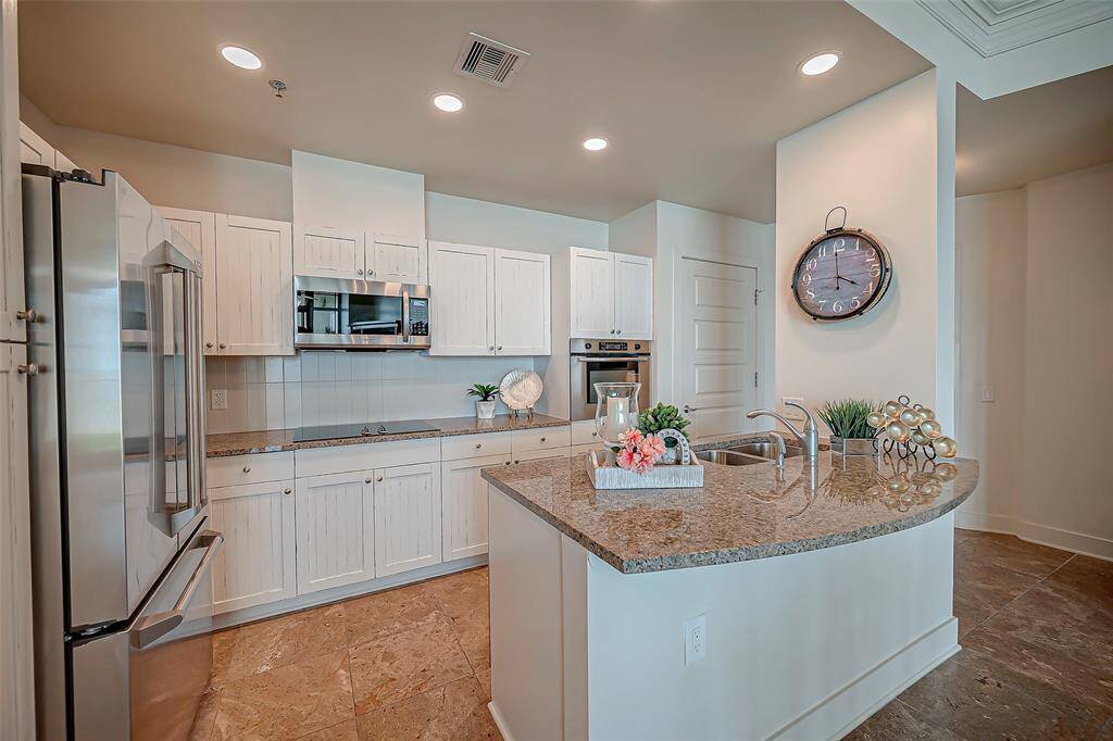 Large breakfast area, with 10 foot ceilings throughout, custom lighting, crown molding and travertine flooring.  Fully furnished!