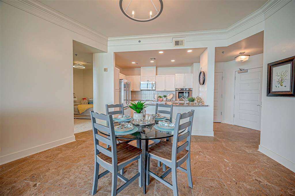 Beautiful beach views from large den area, travertine flooring, crown molding and floor to ceiling windows!  Lots of natural light and neutral!   All furniture conveys!