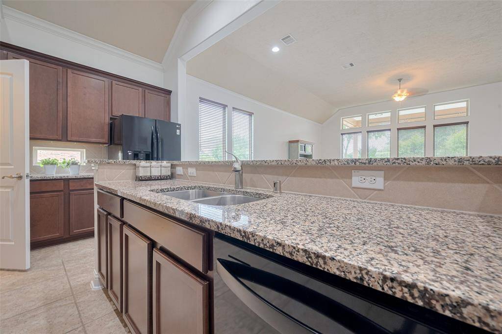 Kitchen offers ample storage, long counters, and a new dishwasher.