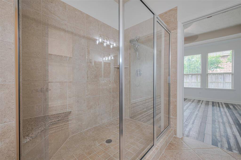 Huge glass-enclosed shower.
