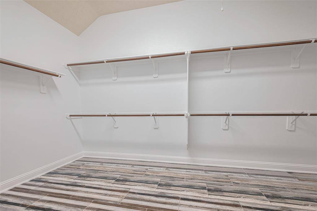 Spacious full-entry closet has built-in shelving.