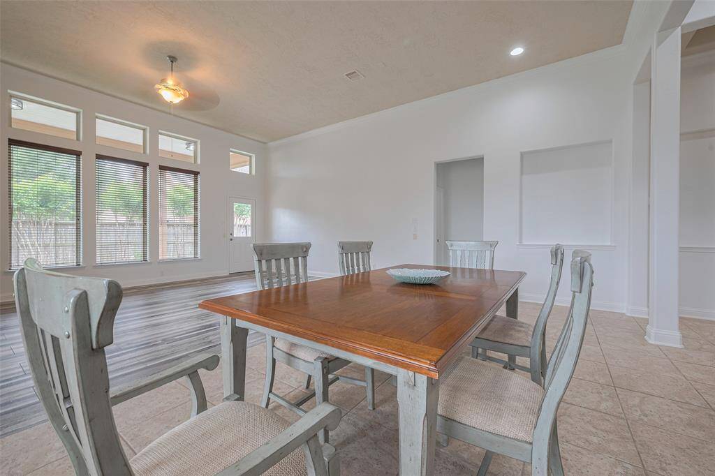 Sunlit dining area nestled between kitchen and living room.