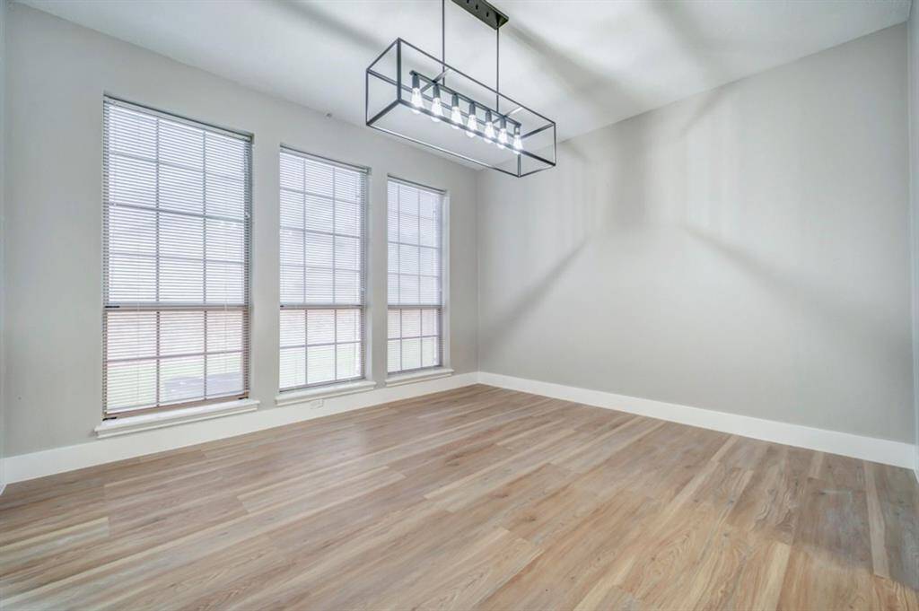 The dining room has large windows that allow natural lighting