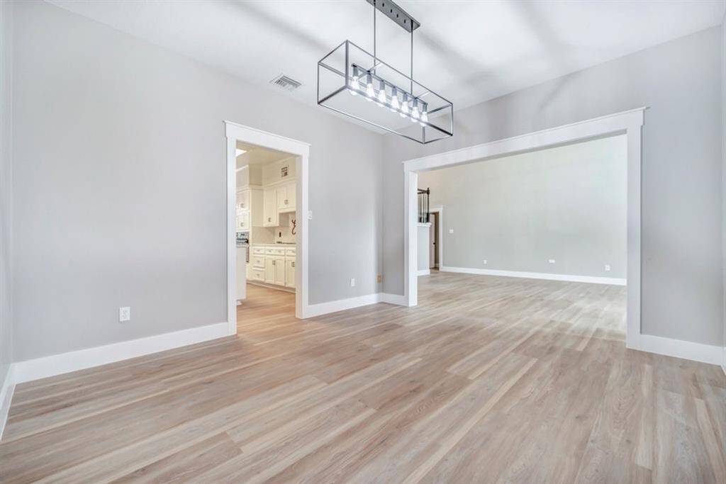 The dining room opens to the living room and kitchen