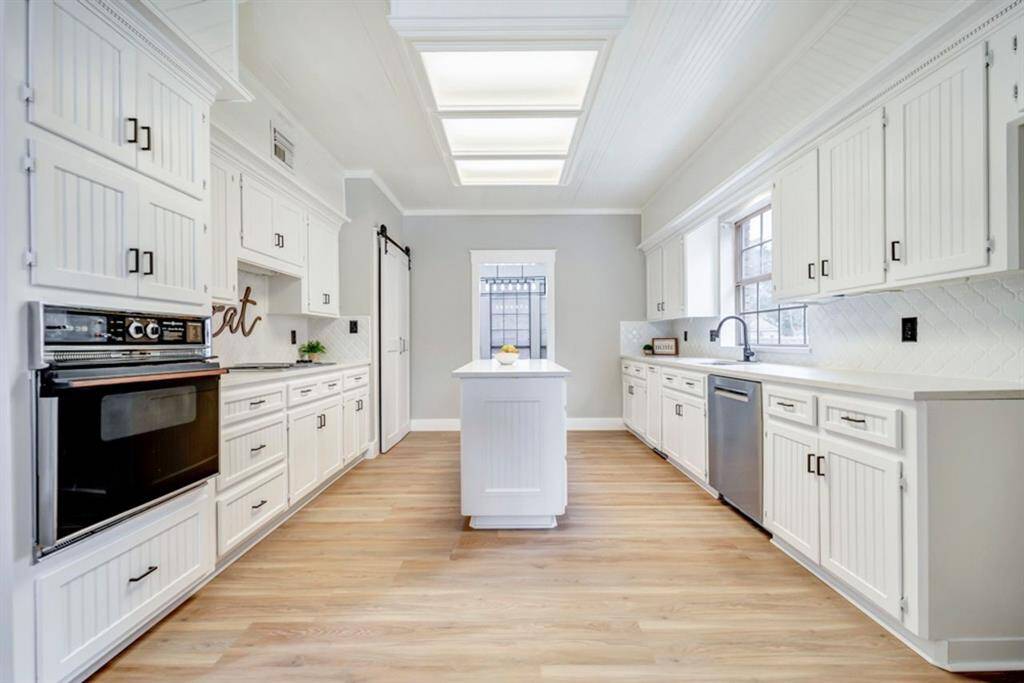 Step inside the kitchen, renovated with new quartz countertops and backsplash as well as fresh paint