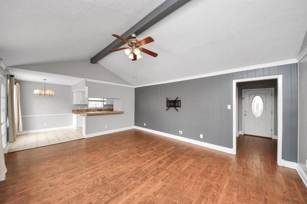 Experience spacious elegance in this main living area, featuring high ceilings and seamless access to the kitchen and breakfast nook.