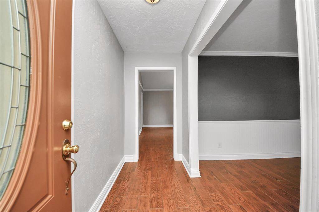 Step into your new home with inviting hardwood floors and a spacious entryway that welcomes you warmly.