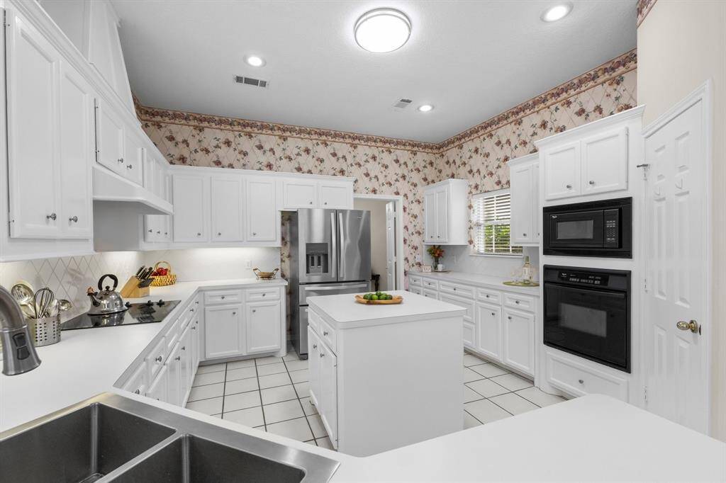 Everyone loves a deep Undermount stainless steel sink, built-ins, a cooktop and a walk-in pantry!