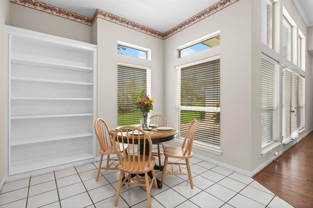 Breakfast area located between the kitchen and the living room, and not too far from the utility room with excellent views through the corner windows out to the covered rear patio.