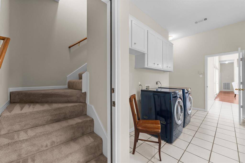 Side Entry from driveway leads into utility room w/ access to stairs for flex room. Room for a full size fridge, washer and gas or electric dryer and a closet.