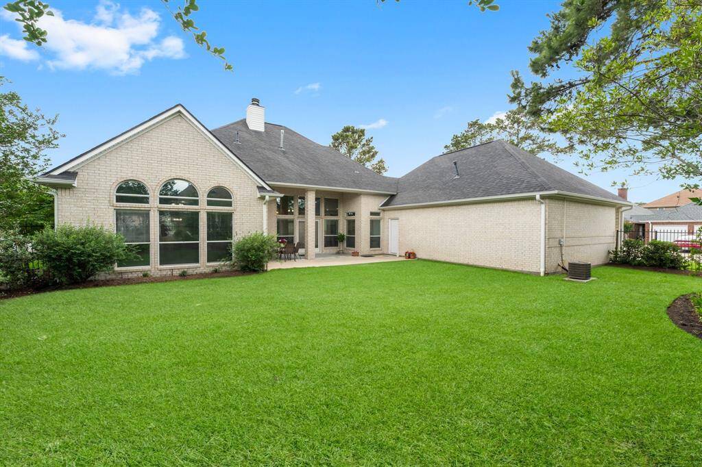 Rear Elevation showcases the large back yard, primary suite windows, huge covered patio and access door straight into the garage. Don't worry, it has a full sprinkler system, too!
