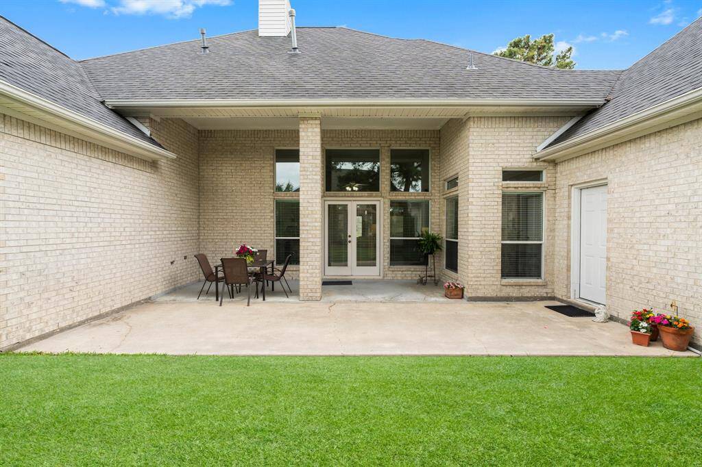 Your back yard covered patio is complete with an extended concrete area while the lush green lawn adds a touch of nature.