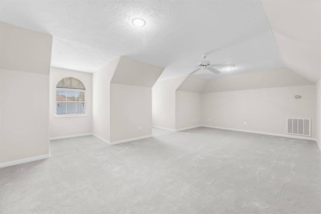 Versatile game room/flex space above the garage with fresh paint and a private entrance. Includes a Ceiling Fan and has it's own A/C unit zoned just for this space!