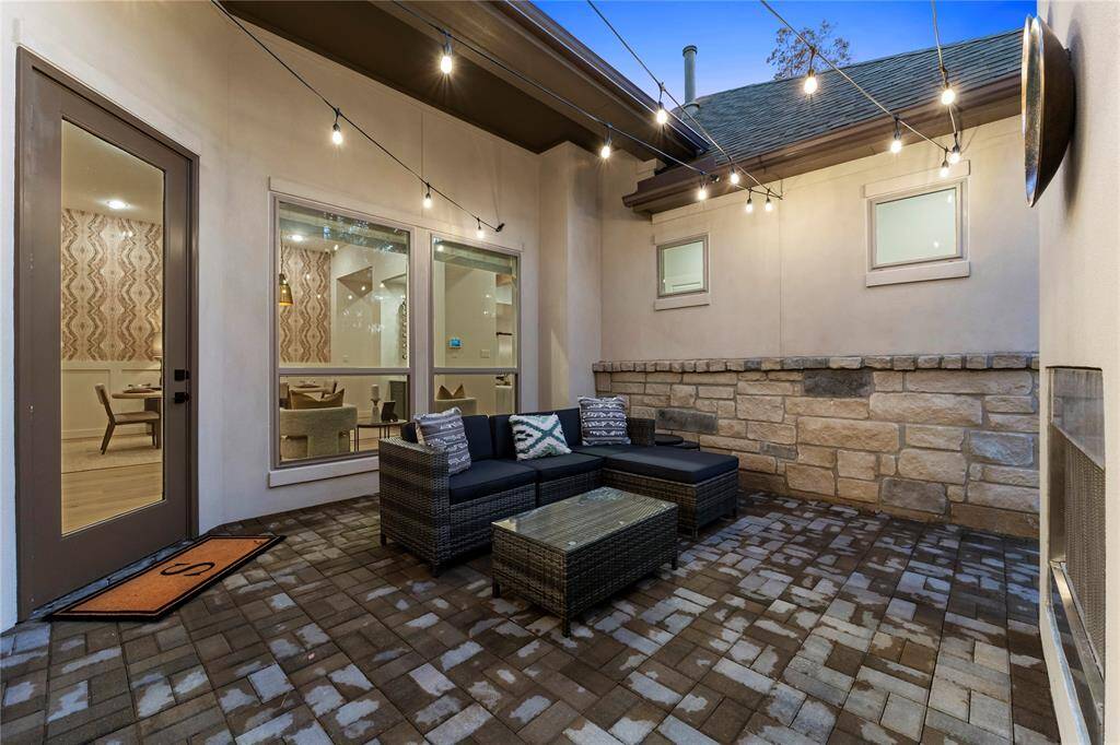 Open Patio with Wood-Burning Fireplace Across from Dining