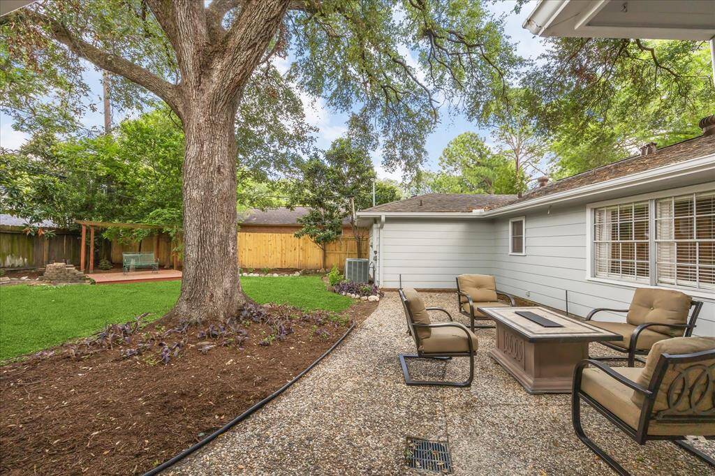 This backyard is your own private oasis with large patio, firepit, deck, and plenty of green space.