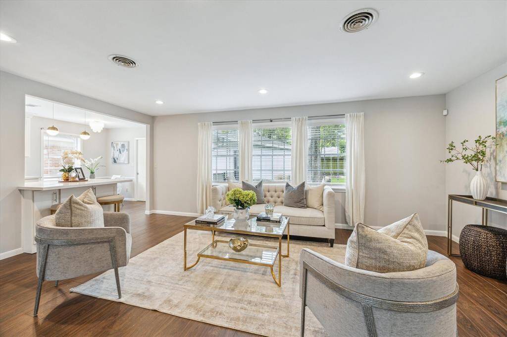 Living room is bright and airy with large windows providing tons of natural light.