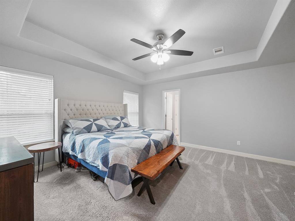 THIS IS THE 1st PRIMARY BEDROOM WITH TWO LARGE WINDOWS AND A PRIVATE AN EN-SUITE BATHROOM.