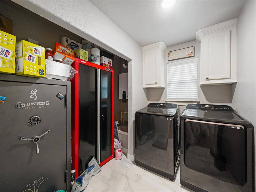 THE LAUNDRY/UTILITY ROOM FEATURES CABINET STORAGE SPACE AND A HUGE CLOSET ALSO!