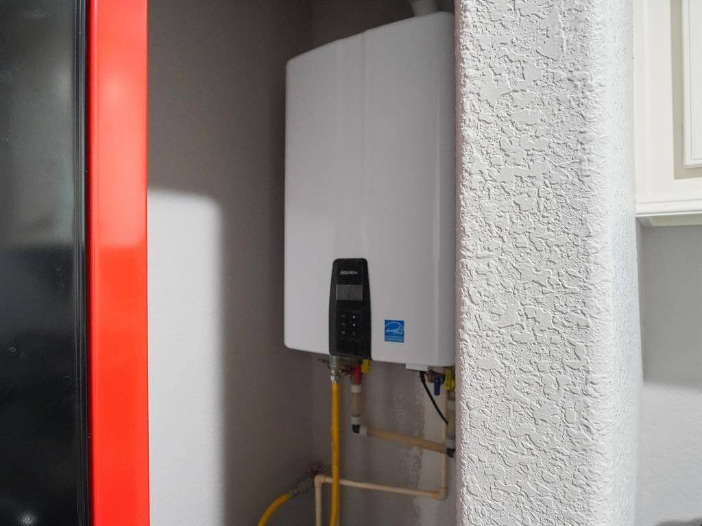 TANKLESS WATER HEATER IS LOCATED IN THE LAUNDRY/UTILITY ROOM AND IT IS INCLUDED WITH THE HOME.