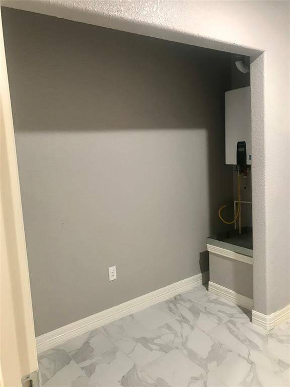 The laundry room storage closet where the tankless water heater is also.