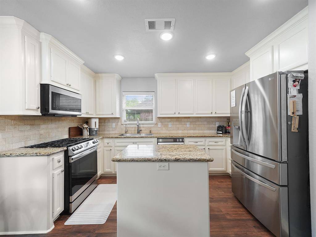 LOTS OF CABINET STORAGE AND COUNTER WORK-SPACE WHICH INCLUDES AN ISLAND AS WELL!