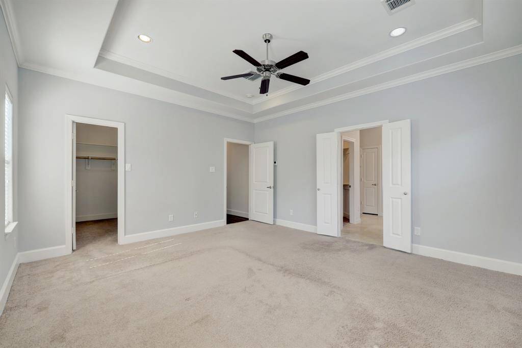 The spacious primary even has raised ceilings.