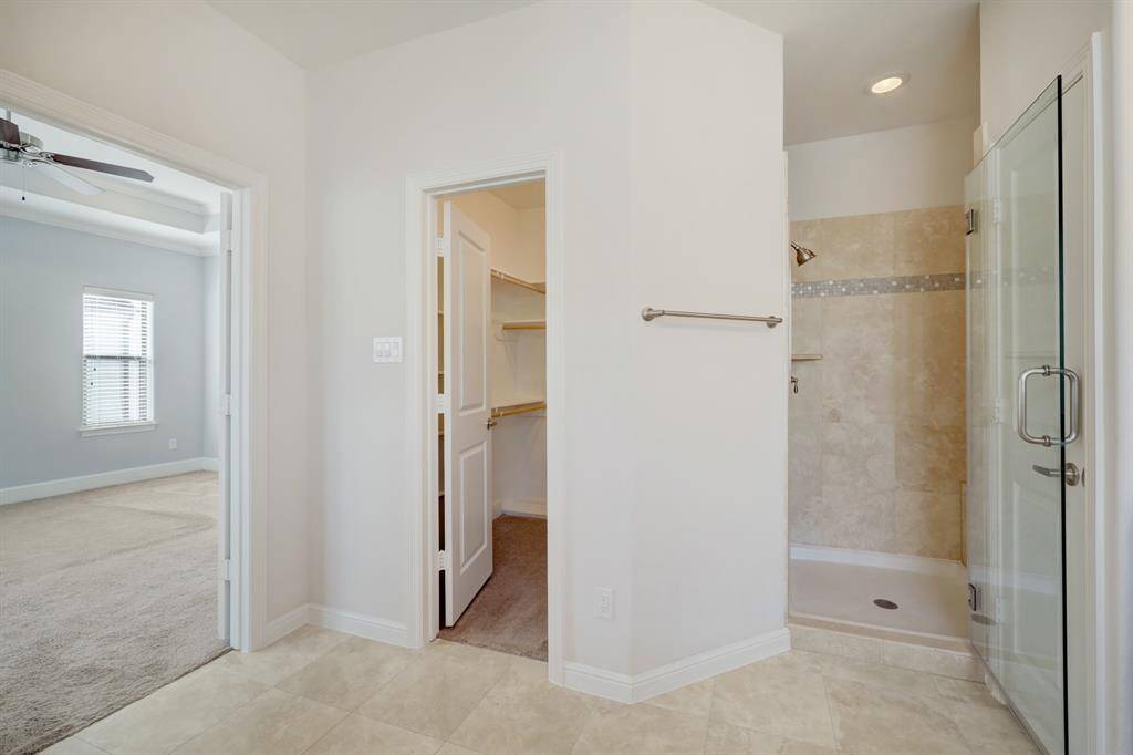 Primary bathroom has double vanities, spa tub and a walk-in shower.