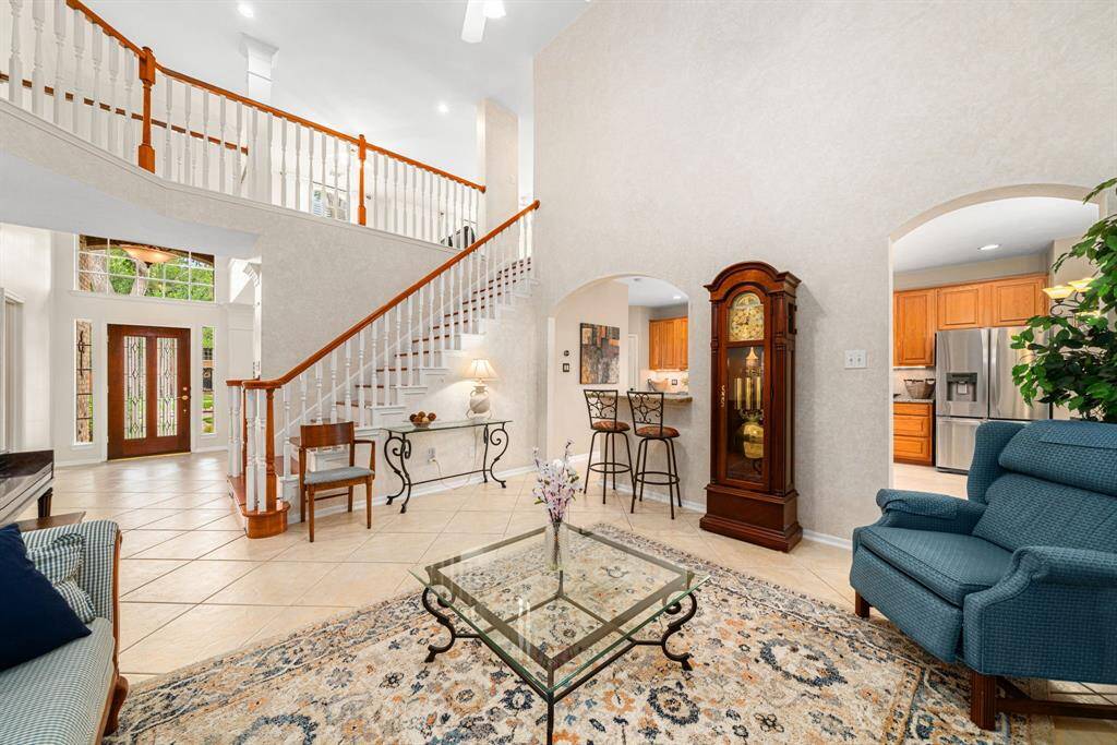 High ceilings and a grand staircase, highlight the spaciousness of this home with an airy, open feel. Natural light pours in through an abundance of windows.