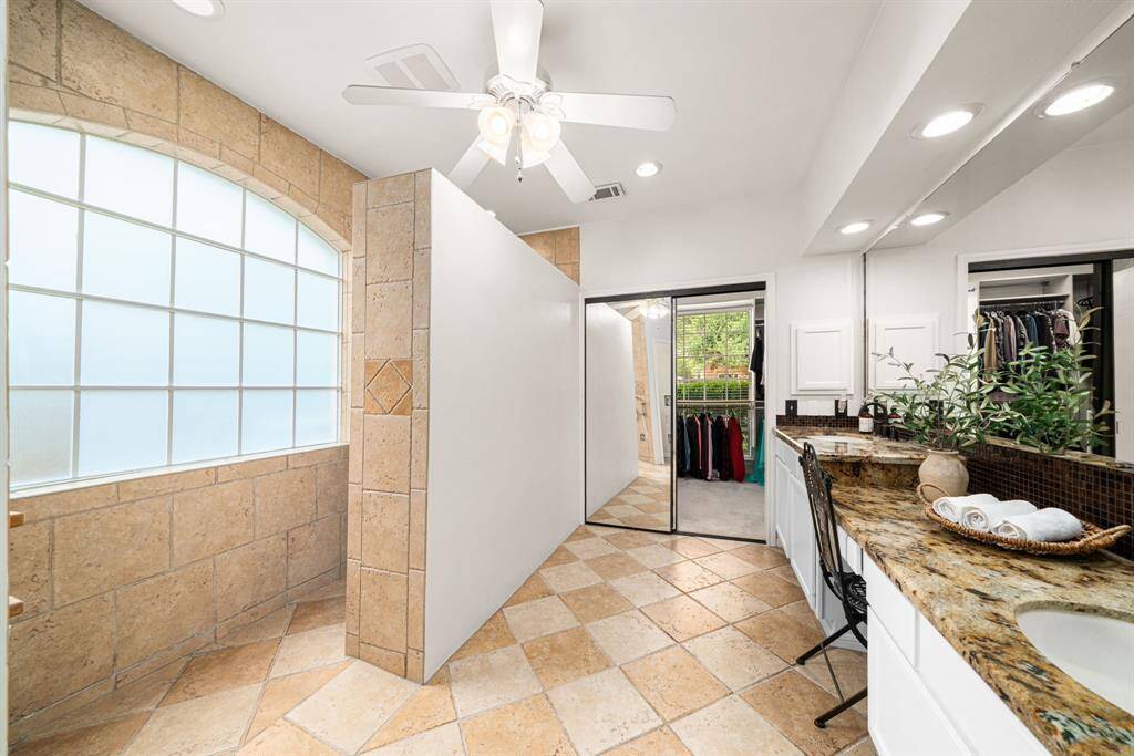 Warm tile flooring complements the neutral walls, recessed lighting for a bright space and ceiling and exhaust fans for great ventilation.
