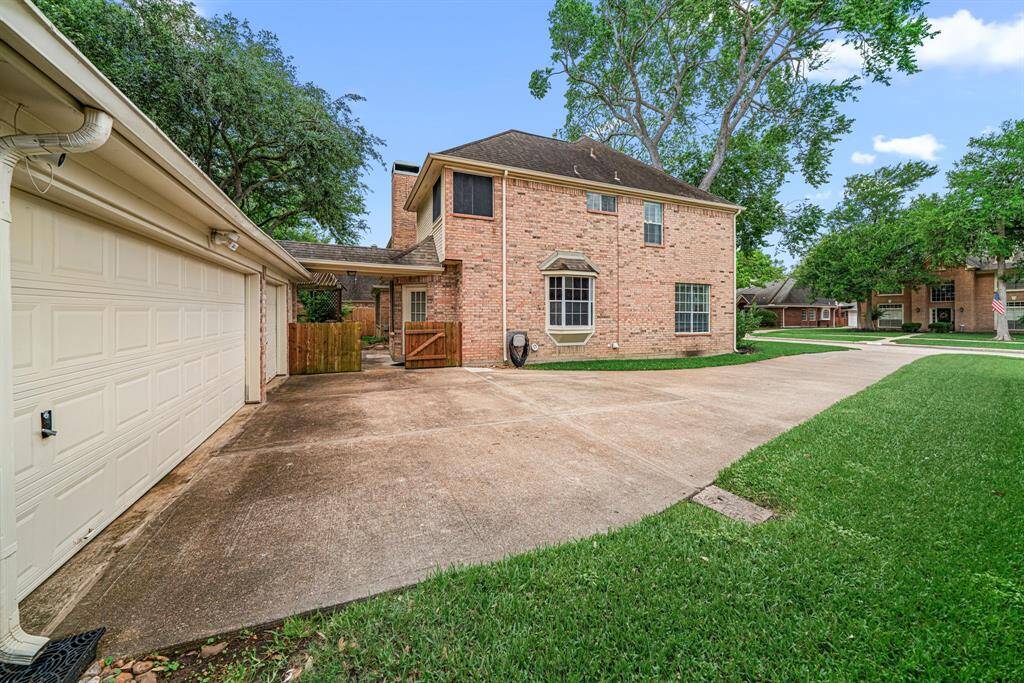 Driveway broadens to accommodate three vehicle spaces approaching the 3 car garage.