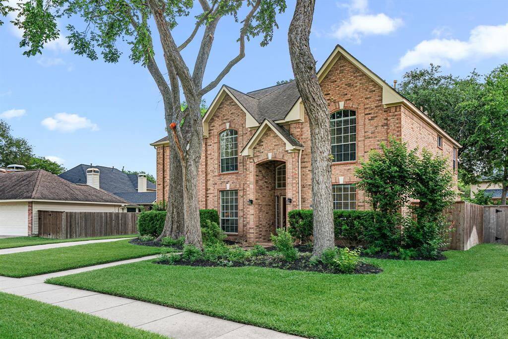 This beautiful Greatwood home is surrounded by mature trees and well-maintained landscaping, offering charming curb appeal.