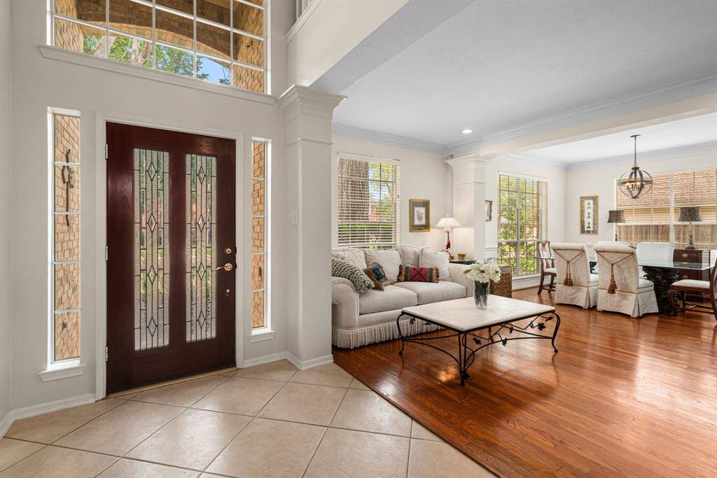 Light, bright and inviting open formal living space and formal dining with beautiful hardwood flooring located just off of the entryway.