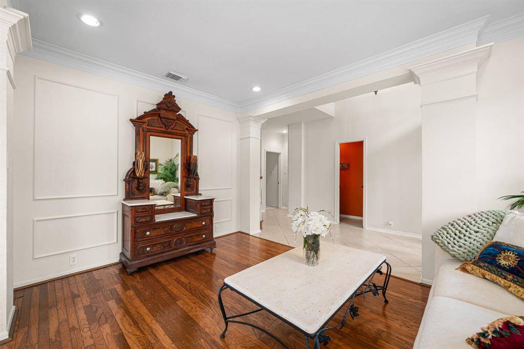 This inviting formal living space features recessed lighting, accentuated with picture frame molding and crown molding.