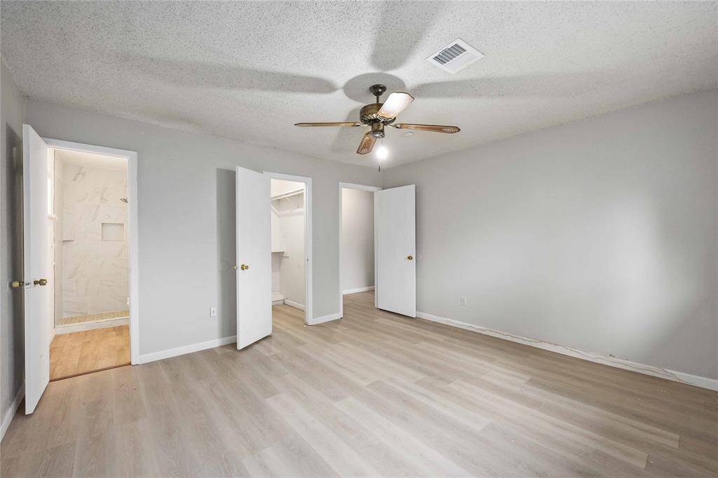 Primary bedroom has ensuite bath along with a walk in closet big enough to share