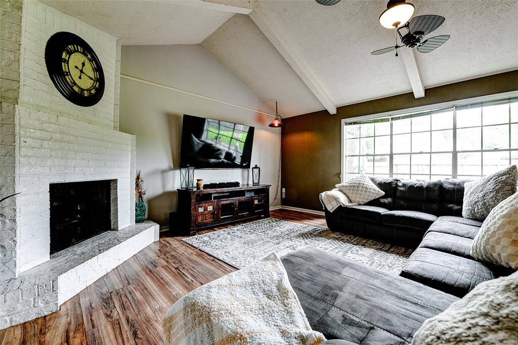 Spacious living room with gorgeous fireplace as focal point.