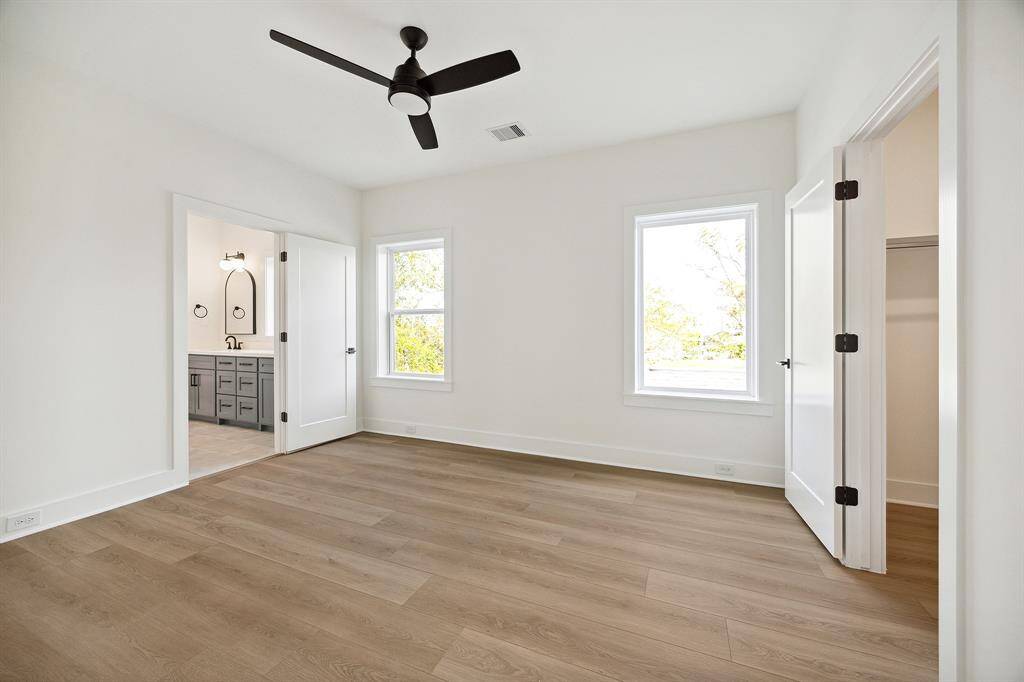 Third bedroom offers a walk-in closet, modern ceiling fan and access to the jack and jill bath
