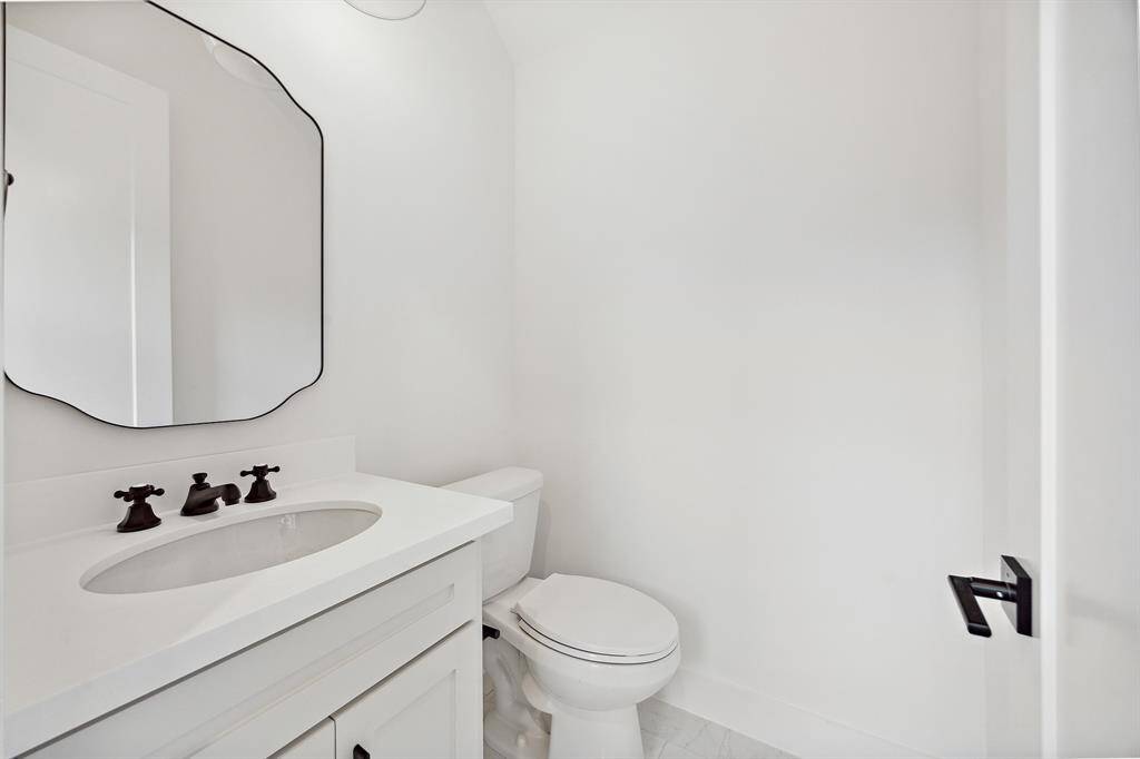 This powder bath will make your guests swoon! Elegant hardware and framed mirror bring plenty of personality and style