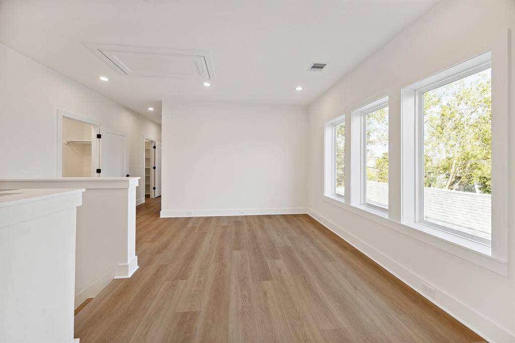 Enter the second floor which offers flex space for sitting area or game room. Walk-in utility room pictured off the hallway