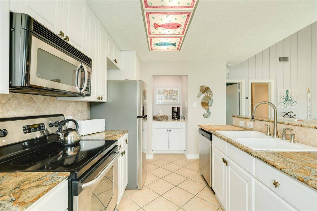 Kitchen with stainless appliances and built in coffee bar area that could be used as wine area.