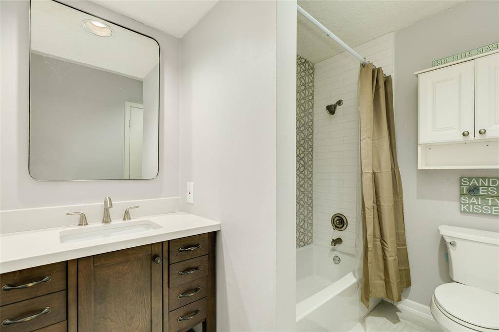 Recently updated primary bathroom with decorative tile.