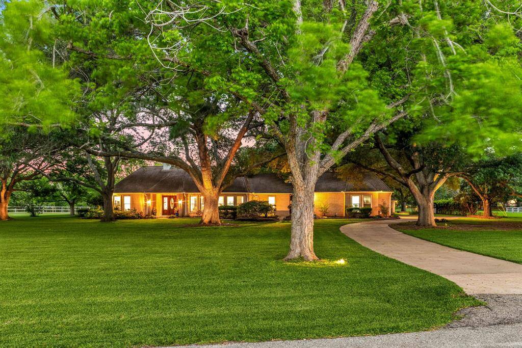 This stunning home has lovely curb appeal surrounded by beautiful mature oak trees for a serene peacuful vibe.
