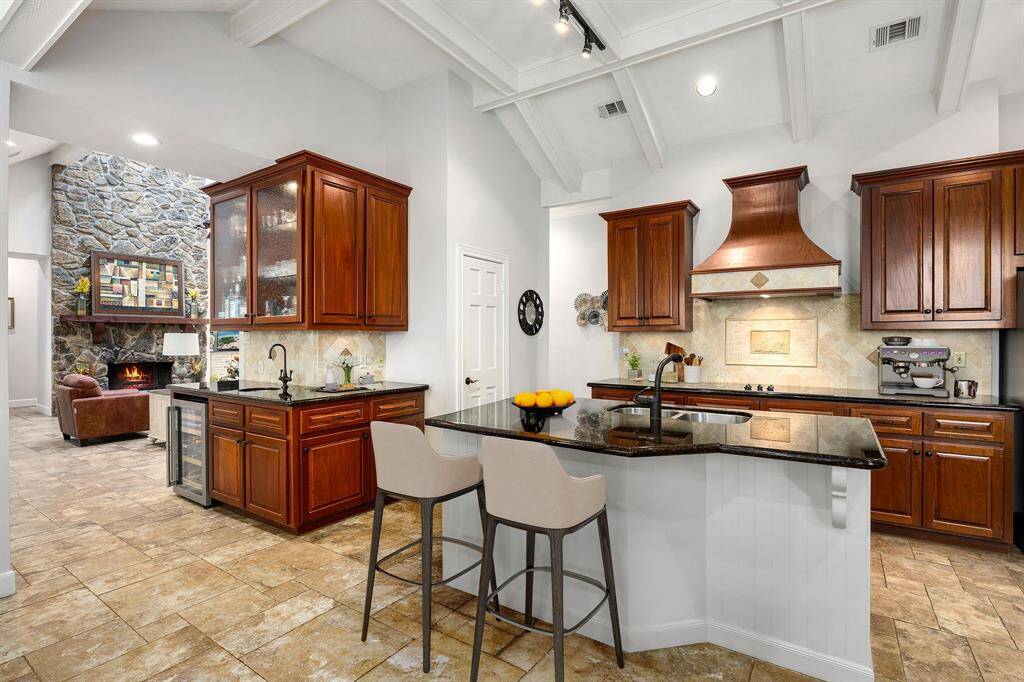 This kitchen is by far any chef’s dream! This spacious kitchen features large windows, high ceilings, dark stained wood cabinets, granite countertops, SS appliances, modern tile backsplash, recessed lighting, granite kitchen island with double sink and space for breakfast bar and a walk-in pantry. *Virtually Staged