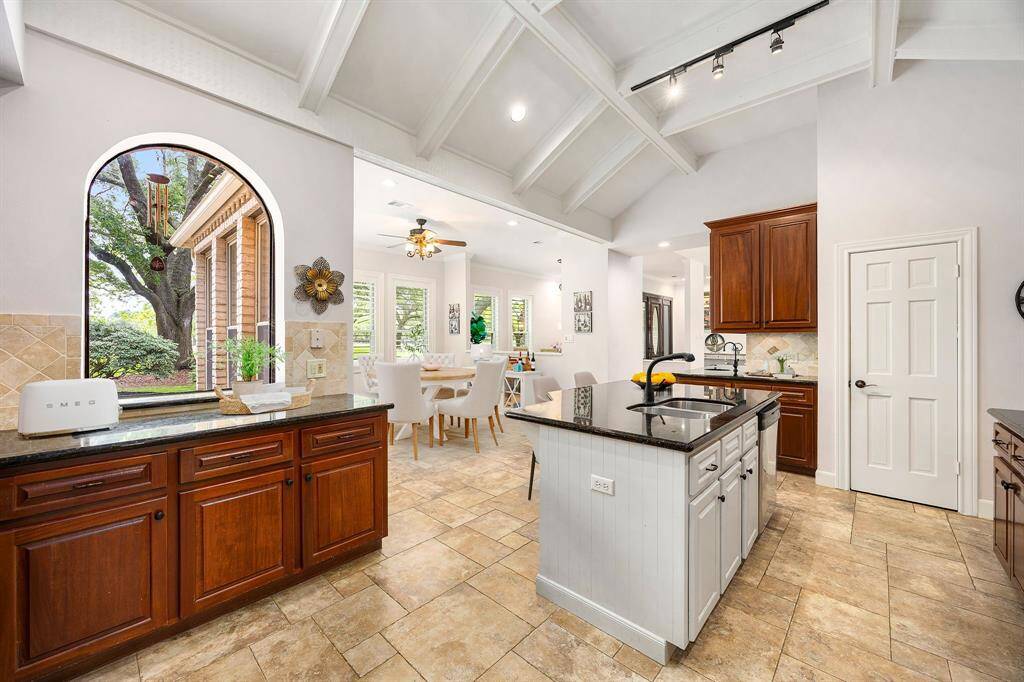 Cook with a view! This bright and inviting kitchen features ample counter space, sleek cabinetry, and a large window that fills the space with natural light and offers a picturesque view making every meal prep feel like a treat. *Virtually Staged